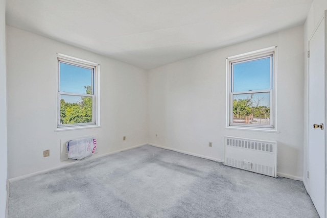 190 W Merrick Rd Unit 4E, Freeport, NY 11520 - carpeted spare room featuring radiator heating unit and baseboards