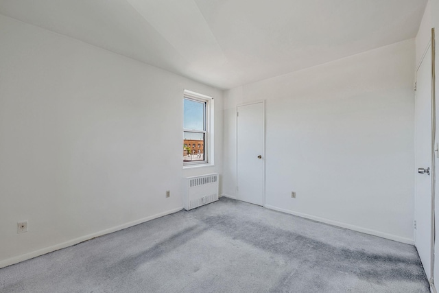 190 W Merrick Rd Unit 4E, Freeport, NY 11520 - empty room with radiator heating unit and light carpet