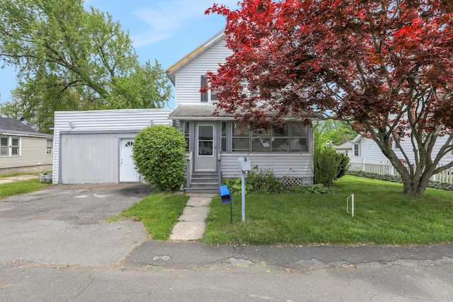 100 Harwich St, Kingston, NY 12401 - obstructed view of property featuring a front yard, asphalt driveway, entry steps, and a detached garage