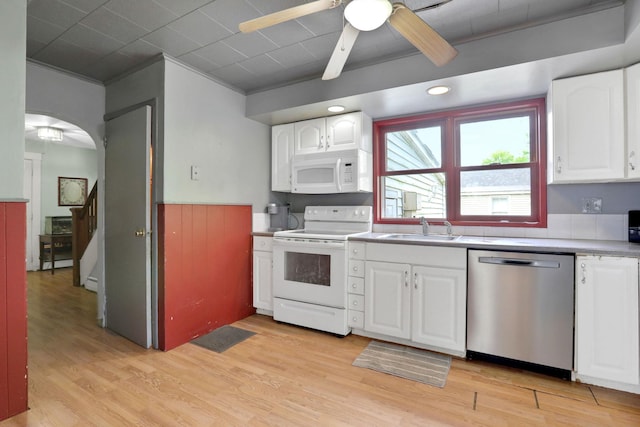 100 Harwich St, Kingston, NY 12401 - kitchen featuring white appliances, a sink, ceiling fan, light wood-style flooring, and white cabinets