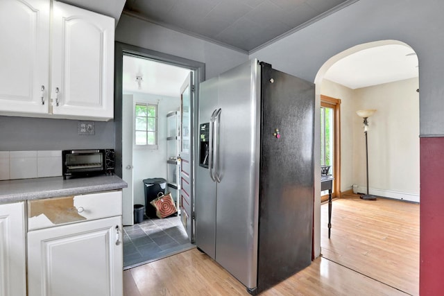 100 Harwich St, Kingston, NY 12401 - kitchen featuring stainless steel refrigerator with ice dispenser, arched walkways, white cabinetry, and light wood-type flooring