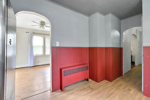 100 Harwich St, Kingston, NY 12401 - corridor with radiator heating unit, arched walkways, light wood-style floors, a wainscoted wall, and crown molding
