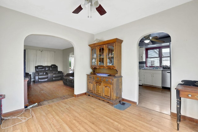 100 Harwich St, Kingston, NY 12401 - living room featuring a ceiling fan, arched walkways, light wood-type flooring, and baseboards