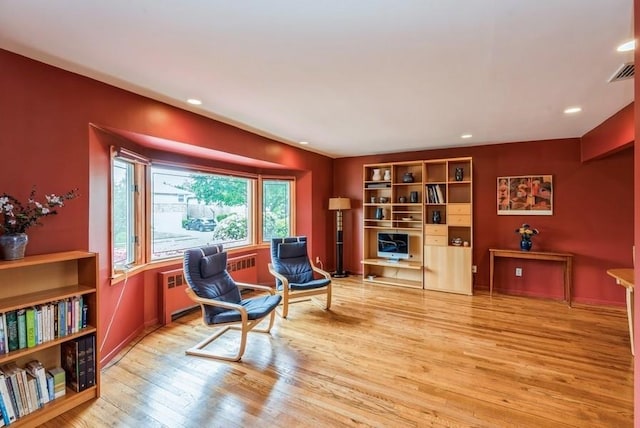 95 Nassau Ave, Plainview, NY 11803 - sitting room with wood finished floors, recessed lighting, and radiator