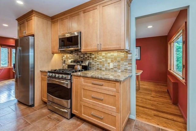 95 Nassau Ave, Plainview, NY 11803 - kitchen with appliances with stainless steel finishes, healthy amount of natural light, light stone counters, tasteful backsplash, and recessed lighting