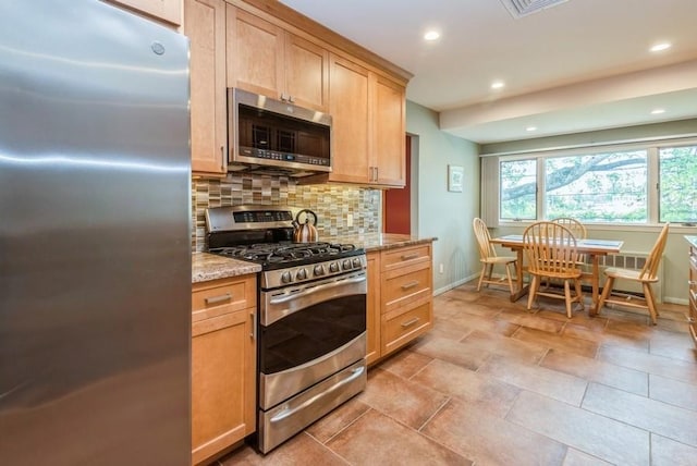 95 Nassau Ave, Plainview, NY 11803 - kitchen with stainless steel appliances, baseboards, decorative backsplash, light stone counters, and recessed lighting