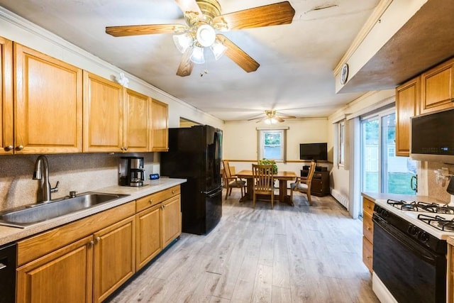 kitchen featuring range with gas stovetop, a sink, freestanding refrigerator, a ceiling fan, and stainless steel microwave