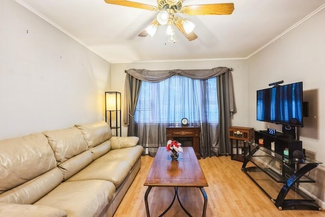 living room featuring light wood finished floors, ceiling fan, ornamental molding, and a baseboard radiator