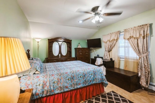 bedroom with wood finished floors, lofted ceiling, and a ceiling fan