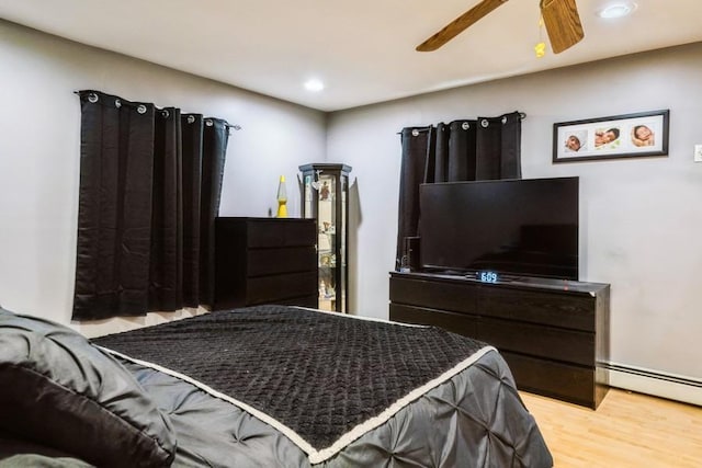 bedroom featuring light wood-style flooring, recessed lighting, a ceiling fan, and a baseboard radiator