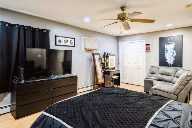 bedroom featuring light wood-style floors, recessed lighting, ceiling fan, and a baseboard radiator