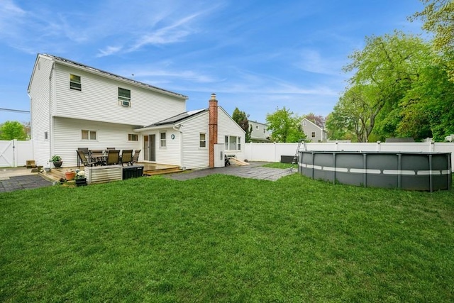 back of house featuring a patio and a wooden deck