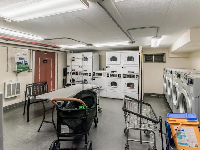 10813 Seaview Ave Unit 41B, Brooklyn, NY 11236 - communal laundry room featuring stacked washer / dryer, separate washer and dryer, baseboards, and a textured ceiling