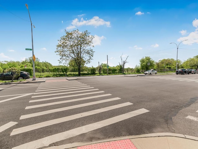 10813 Seaview Ave Unit 41B, Brooklyn, NY 11236 - view of asphalt road featuring street lights, curbs, and sidewalks