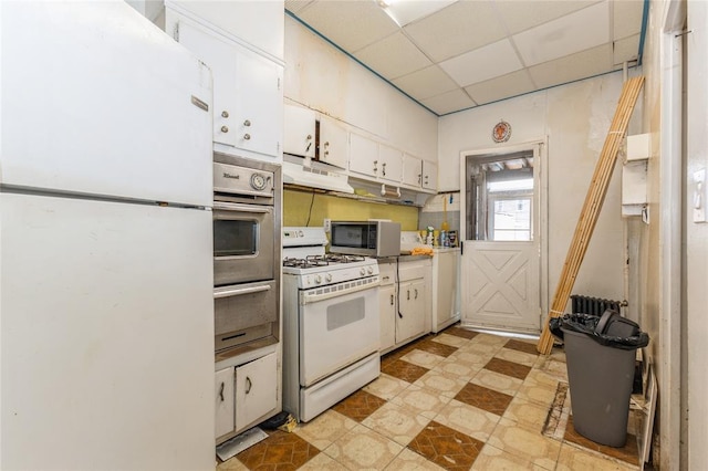 171 Hale Ave, Brooklyn, NY 11208 - kitchen featuring stainless steel appliances, a warming drawer, a drop ceiling, white cabinetry, and under cabinet range hood
