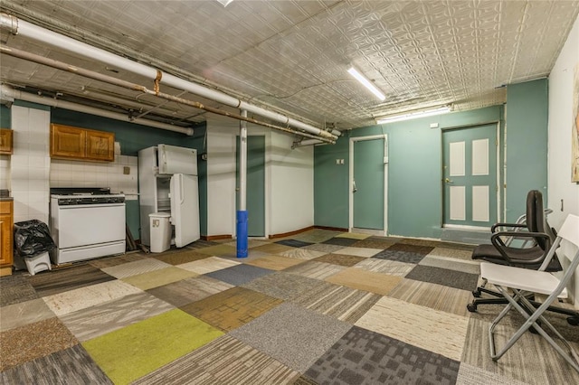 171 Hale Ave, Brooklyn, NY 11208 - below grade area featuring freestanding refrigerator and baseboards