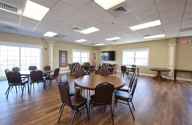 812 Willow Ln, Valley Stream, NY 11580 - dining room with ornate columns, dark wood-style flooring, a paneled ceiling, plenty of natural light, and baseboards