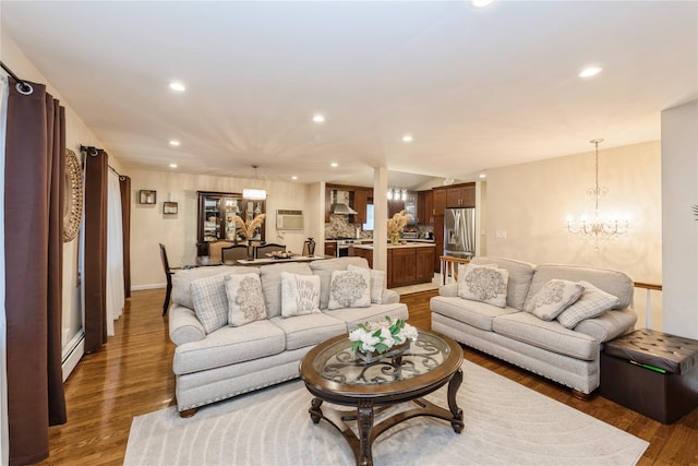 91-10 164th, Howard Beach, NY 11414 - living area with wood finished floors, a chandelier, recessed lighting, a wall mounted air conditioner, and baseboards