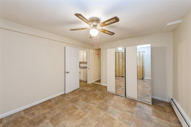 91-10 164th, Howard Beach, NY 11414 - unfurnished bedroom featuring baseboard heating, stone finish flooring, baseboards, and a ceiling fan