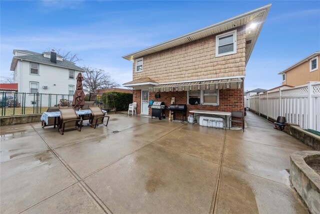 91-10 164th, Howard Beach, NY 11414 - back of property featuring a patio area, a fenced backyard, and brick siding