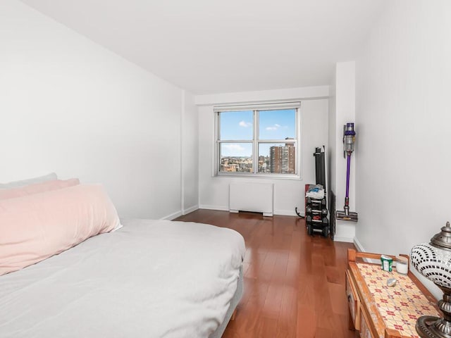 555 Kappock St Unit 18C, Bronx, NY 10463 - bedroom featuring radiator heating unit, wood finished floors, and baseboards