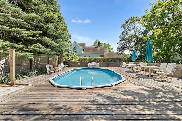 30 Railroad Ave, Center Moriches, NY 11934 - view of pool with a wooden deck, a fenced backyard, and outdoor dining space