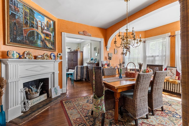 30 Railroad Ave, Center Moriches, NY 11934 - dining room featuring a chandelier, wood-type flooring, and a fireplace