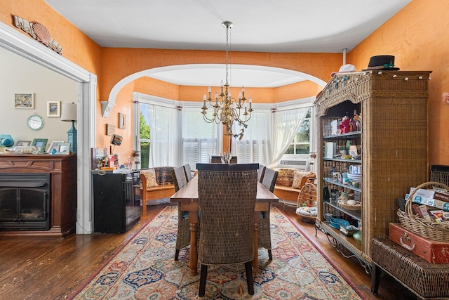 30 Railroad Ave, Center Moriches, NY 11934 - dining room featuring arched walkways, wood-type flooring, a chandelier, and cooling unit