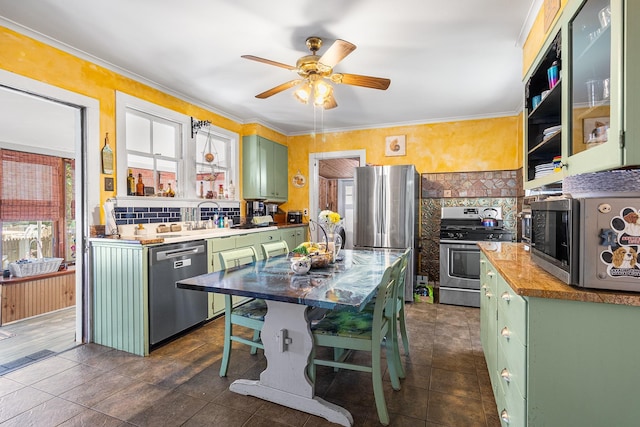 30 Railroad Ave, Center Moriches, NY 11934 - kitchen featuring green cabinetry, stainless steel appliances, ceiling fan, backsplash, and crown molding
