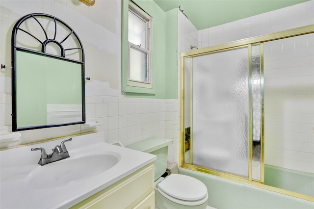 8 Van Siclen Ave, Brooklyn, NY 11207 - bathroom with enclosed tub / shower combo, tile walls, vanity, toilet, and a wainscoted wall