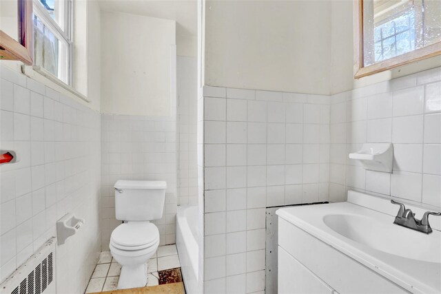 8 Van Siclen Ave, Brooklyn, NY 11207 - full bathroom featuring tile walls, toilet, tile patterned flooring, a tub to relax in, and vanity