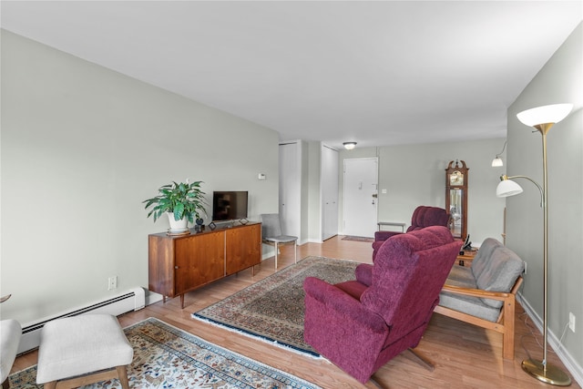 living area featuring wood finished floors and baseboard heating