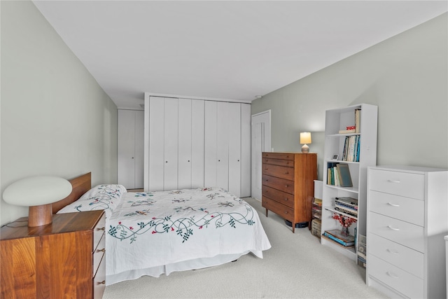 bedroom with light carpet and a closet