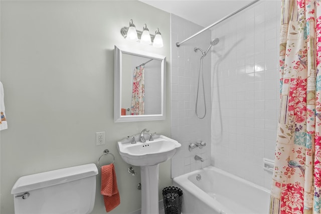 full bath with shower / bathtub combination with curtain, toilet, and a sink