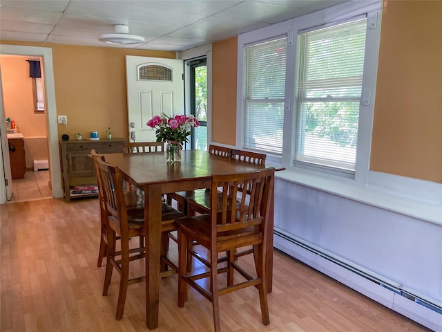 40 Cream St, Poughkeepsie, NY 12601 - dining room featuring a baseboard radiator, light wood-type flooring, and a paneled ceiling