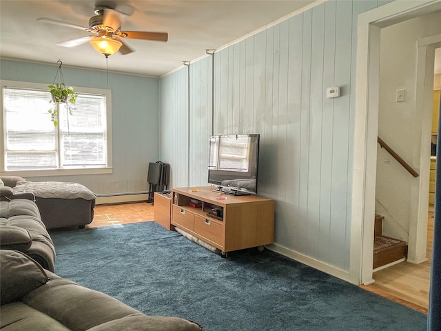 40 Cream St, Poughkeepsie, NY 12601 - carpeted living area featuring a baseboard radiator, ceiling fan, wooden walls, ornamental molding, and baseboards