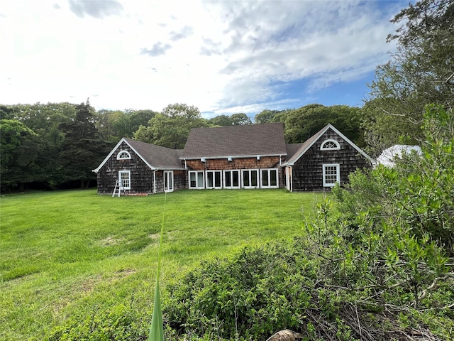 rear view of property featuring a yard
