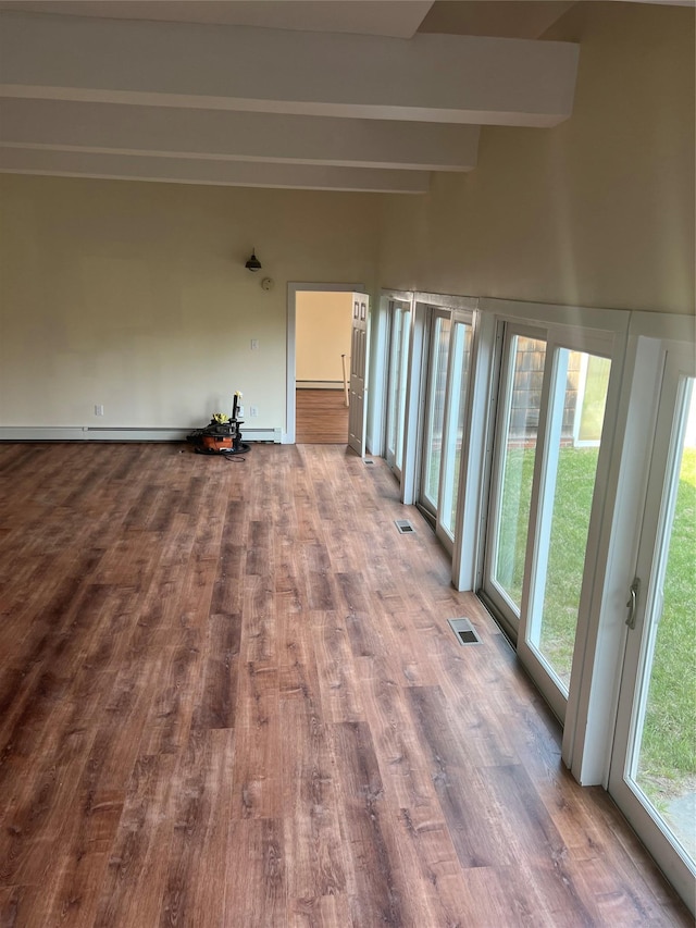 unfurnished sunroom with beamed ceiling and baseboard heating