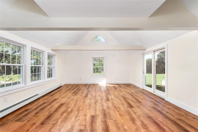 90 W Meadow Rd, East Setauket, NY 11733 - spare room featuring a baseboard heating unit, lofted ceiling, and light wood-style floors