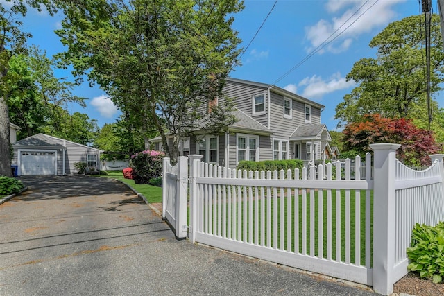 935 Harrison Dr, Centerport, NY 11721 - view of front of property with a garage, driveway, and an outdoor structure