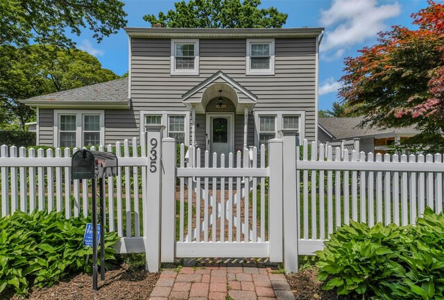 935 Harrison Dr, Centerport, NY 11721 - traditional-style home with a gate and a fenced front yard