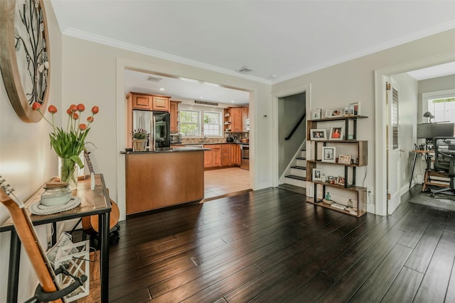 935 Harrison Dr, Centerport, NY 11721 - kitchen with appliances with stainless steel finishes, brown cabinets, dark countertops, wood finished floors, and tasteful backsplash