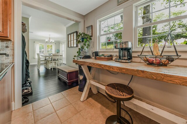 935 Harrison Dr, Centerport, NY 11721 - kitchen with a chandelier, tile patterned flooring, light countertops, and tasteful backsplash