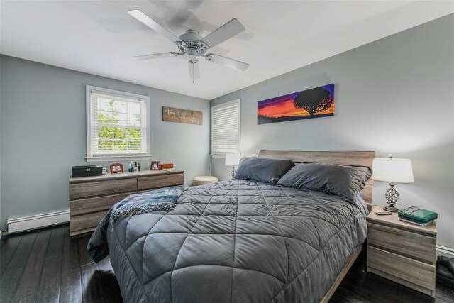935 Harrison Dr, Centerport, NY 11721 - bedroom with a baseboard radiator, dark wood finished floors, baseboards, and a ceiling fan