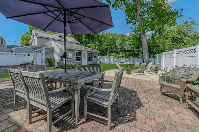 935 Harrison Dr, Centerport, NY 11721 - fenced backyard featuring a patio area, outdoor dining space, an outdoor structure, and a fire pit