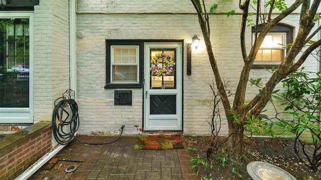 19 Barstow Rd Unit G, Great Neck, NY 11021 - doorway to property with brick siding