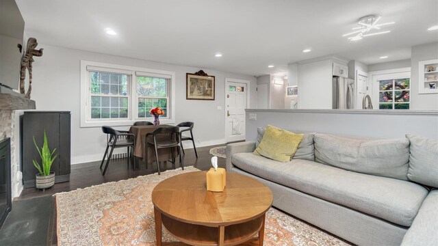 19 Barstow Rd Unit G, Great Neck, NY 11021 - living area featuring baseboards, recessed lighting, wood finished floors, and a glass covered fireplace