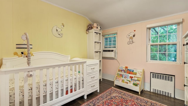 19 Barstow Rd Unit G, Great Neck, NY 11021 - bedroom featuring radiator heating unit, dark wood-style flooring, ornamental molding, a nursery area, and cooling unit