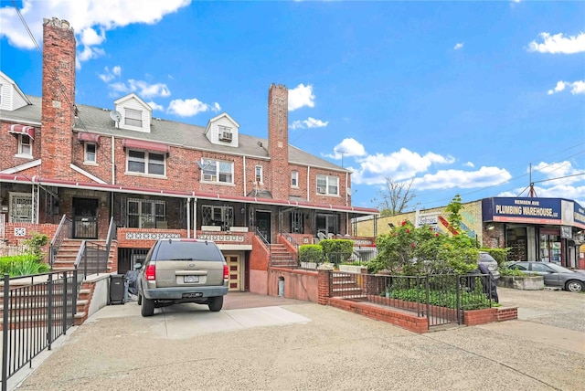 view of front of property with brick siding and a chimney
