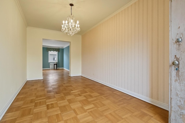 unfurnished dining area with a chandelier, ornamental molding, and baseboards